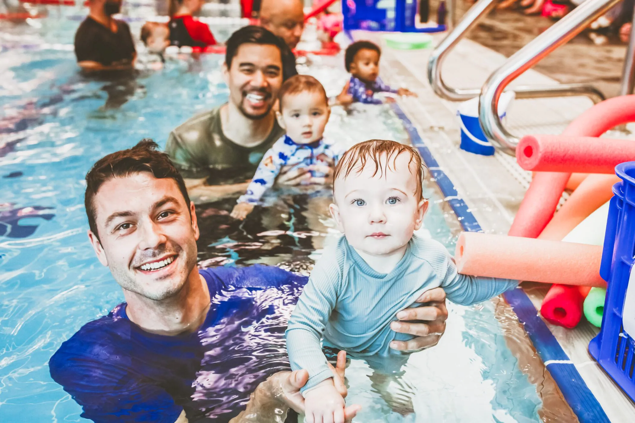 Dads and babies together at the pool edge during a Pymble Swimming parent and baby class