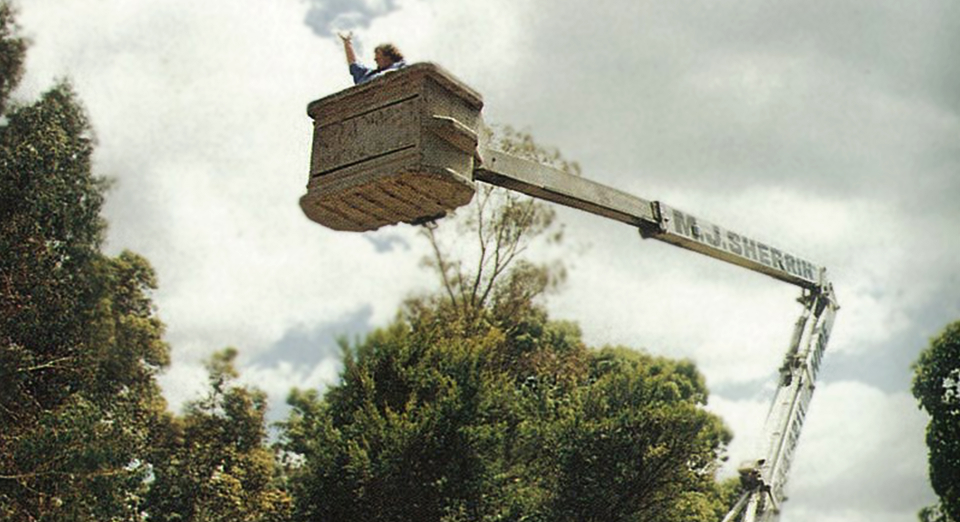 Miss Buckham in a cherrypicker for whole school photograph